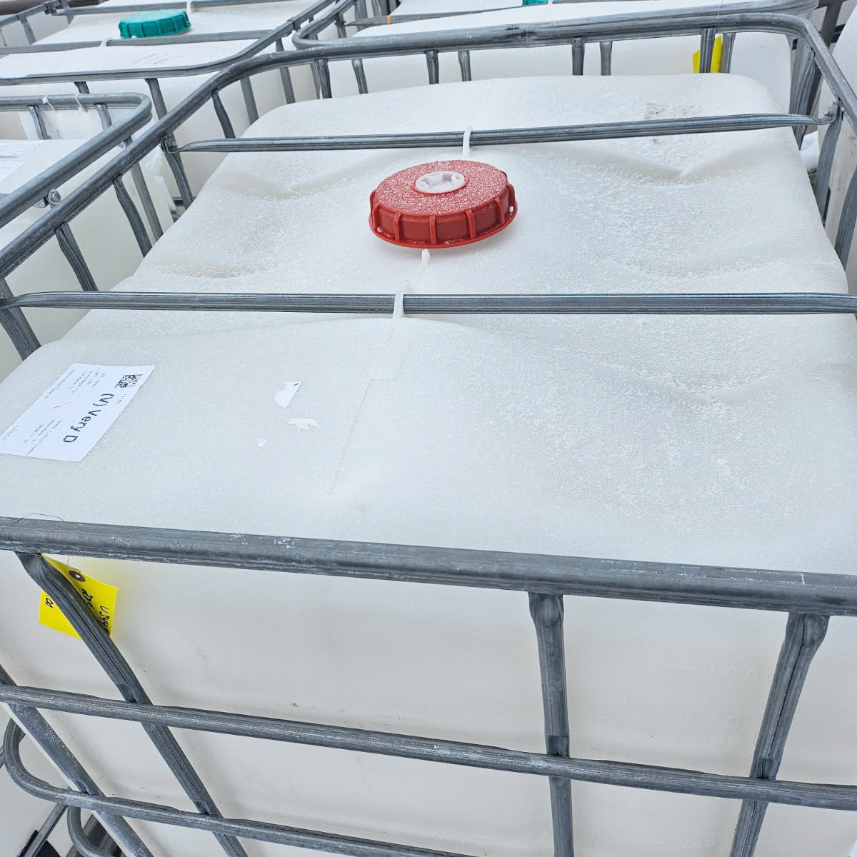 275 +/- Galllon Plastic Tank w/Metal Cage on a Pallet and Valve