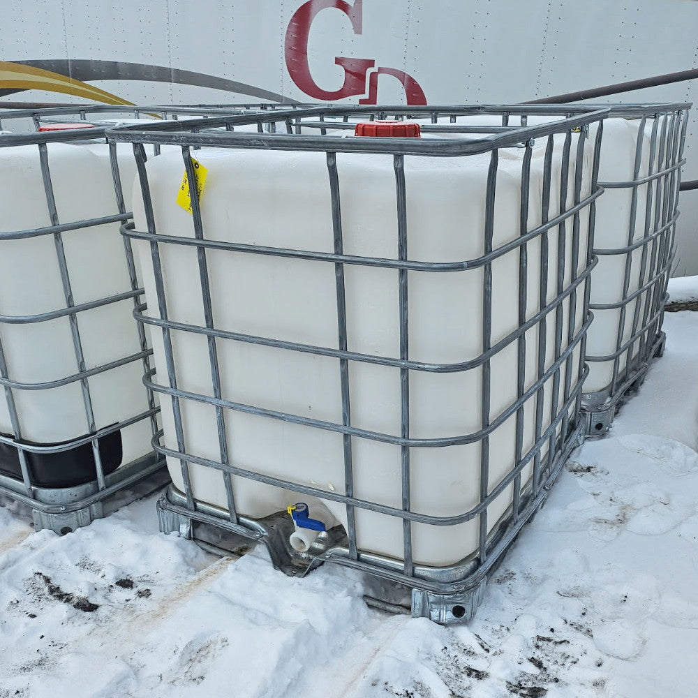 275 +/- Galllon Plastic Tank w/Metal Cage on a Pallet and Valve